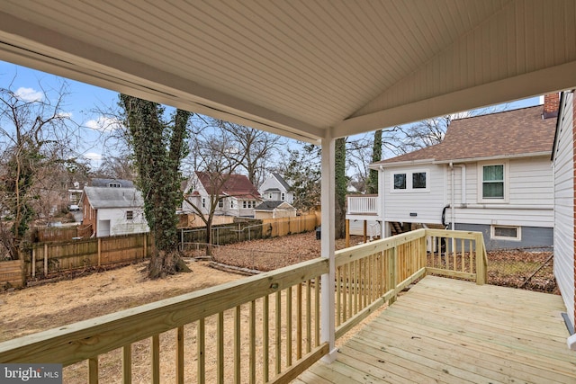 wooden deck featuring a residential view and a fenced backyard