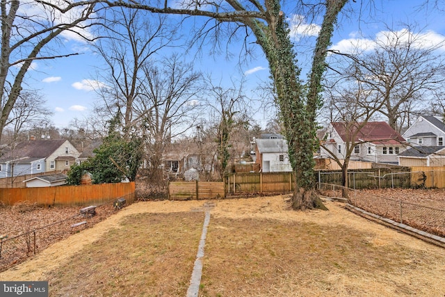 view of yard with a fenced backyard and a residential view