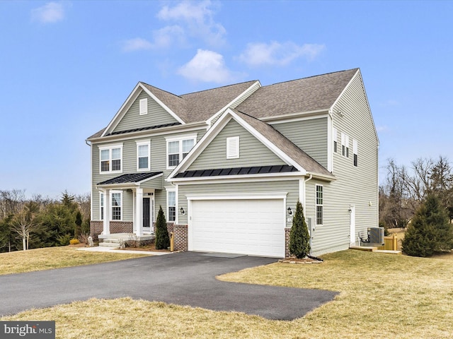 view of front facade featuring driveway, an attached garage, a standing seam roof, cooling unit, and a front yard