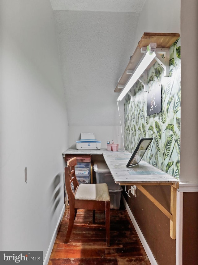 home office featuring vaulted ceiling, baseboards, dark wood finished floors, and a textured ceiling