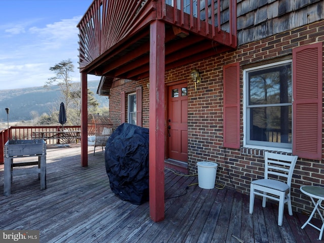 wooden deck with a mountain view