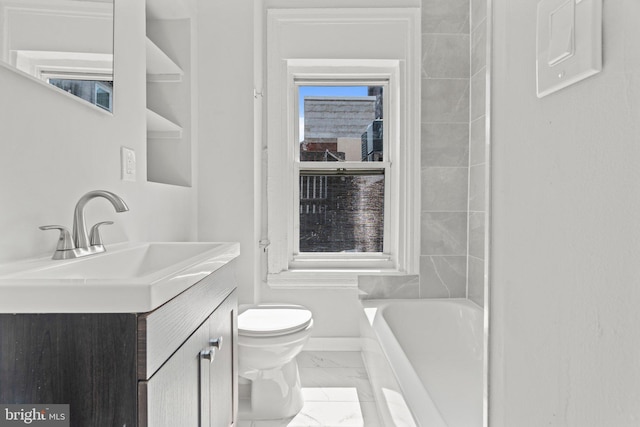 bathroom featuring toilet, vanity, baseboards, marble finish floor, and a bath