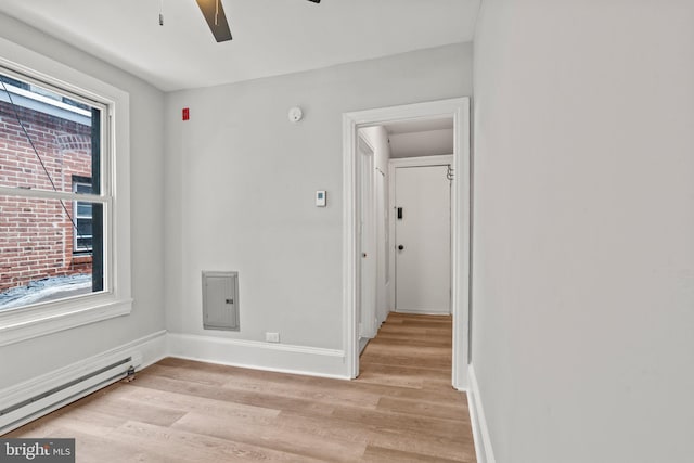 unfurnished room with light wood-style floors, baseboards, baseboard heating, and a ceiling fan