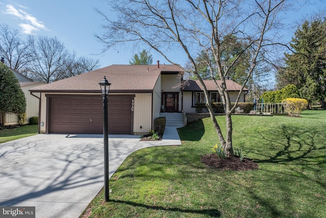 view of front of property with a garage, roof with shingles, concrete driveway, and a front lawn