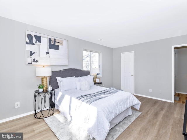 bedroom featuring light wood-type flooring and baseboards