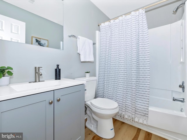 bathroom featuring shower / tub combo, vanity, toilet, and wood finished floors