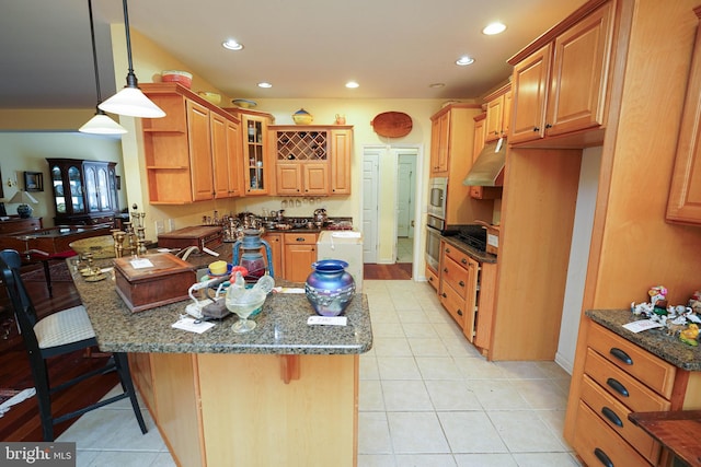 kitchen featuring hanging light fixtures, dark stone countertops, and glass insert cabinets