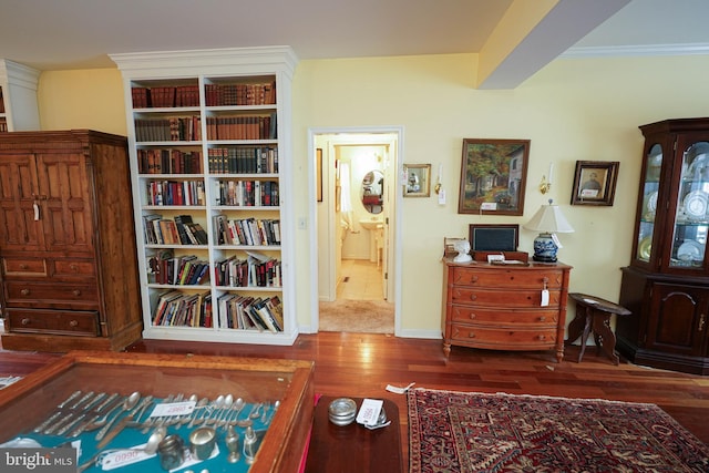 bedroom featuring crown molding, baseboards, and dark wood-style flooring