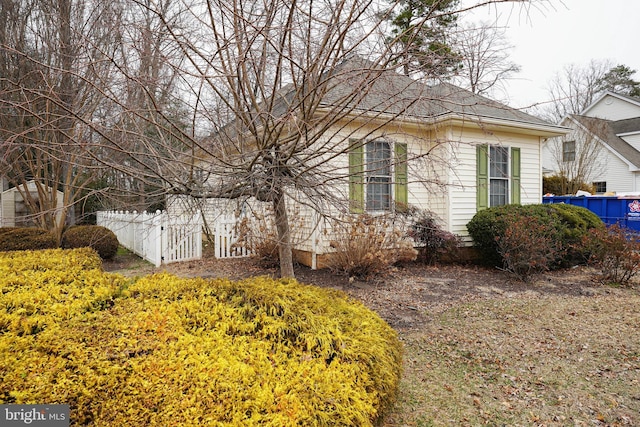 view of home's exterior featuring fence