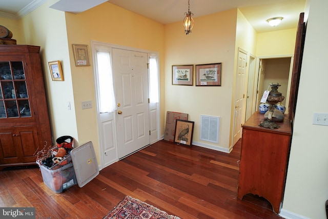 foyer entrance featuring visible vents, dark wood finished floors, and baseboards