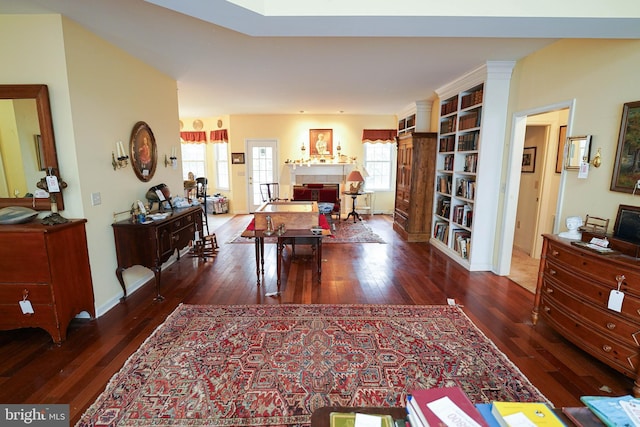 interior space featuring baseboards and dark wood finished floors