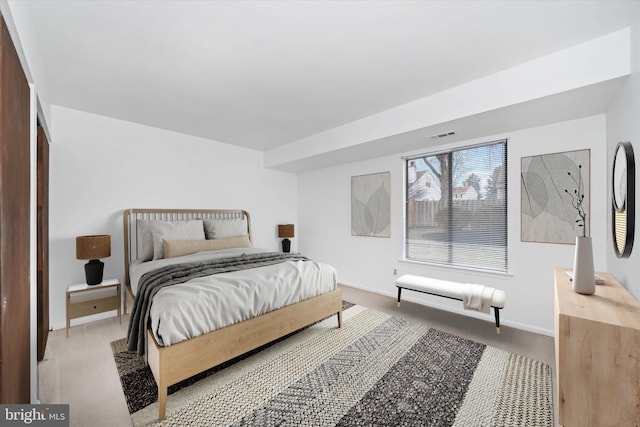 carpeted bedroom with visible vents and baseboards