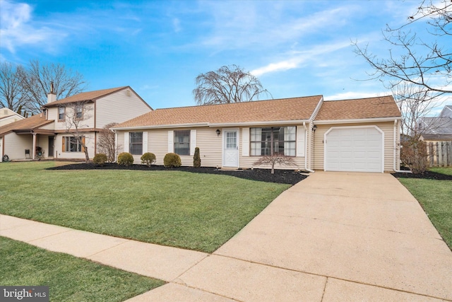 view of front of home with an attached garage, driveway, and a front lawn