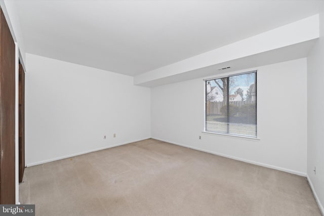 unfurnished bedroom with light carpet, visible vents, and baseboards