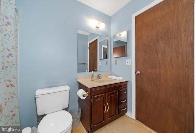 full bathroom featuring vanity and toilet