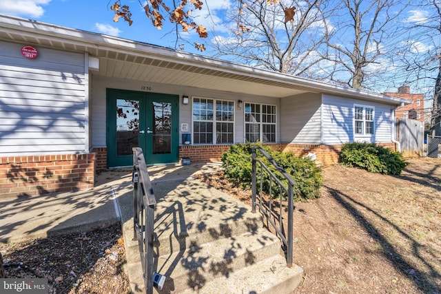 doorway to property with brick siding and french doors