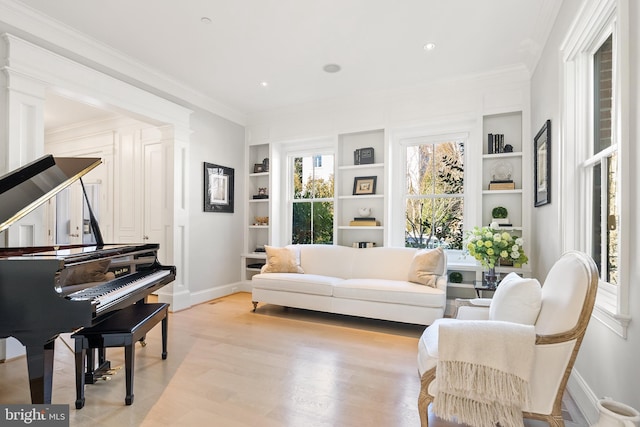 sitting room with built in features, light wood finished floors, recessed lighting, ornamental molding, and baseboards