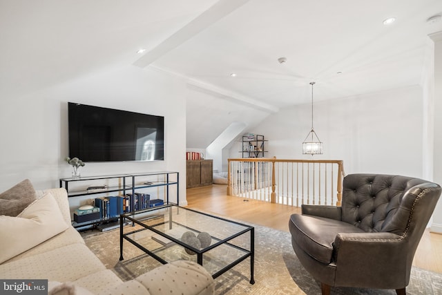 living room with recessed lighting, vaulted ceiling, an inviting chandelier, and wood finished floors