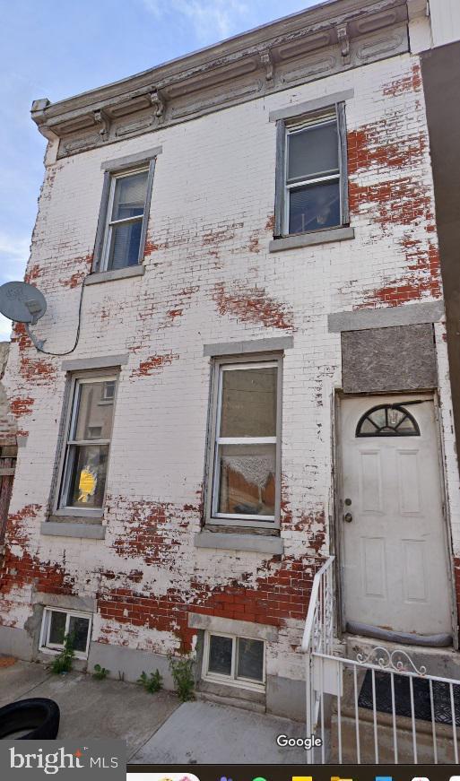 view of home's exterior with entry steps and brick siding