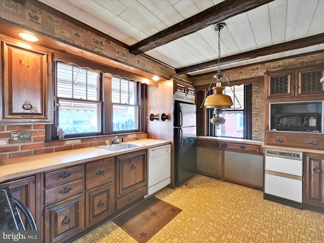 kitchen featuring freestanding refrigerator, black microwave, light countertops, and dishwasher