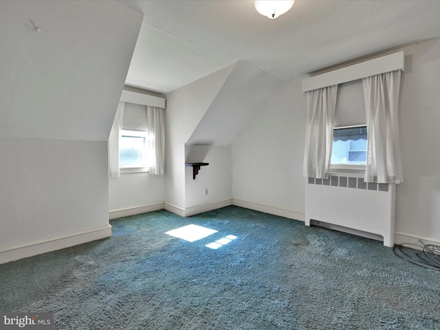 additional living space featuring carpet, radiator, vaulted ceiling, and baseboards