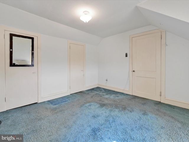 bonus room featuring lofted ceiling and carpet