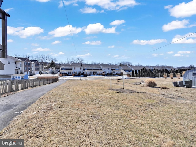 view of yard with a residential view and fence