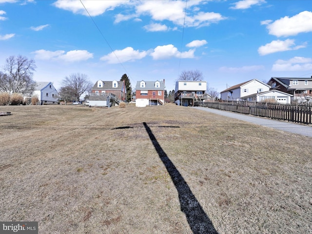 view of yard featuring a residential view and fence