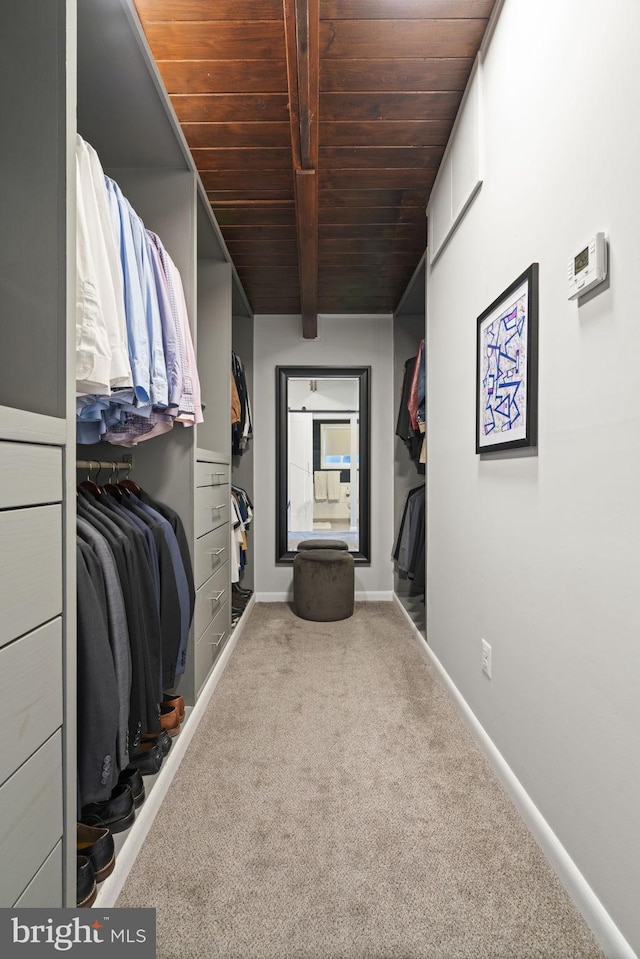 spacious closet with carpet floors and beam ceiling