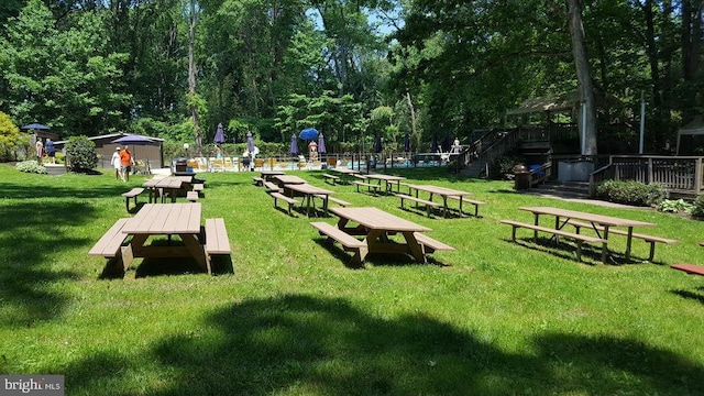 surrounding community featuring a deck and a yard