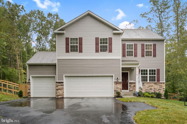 view of front of property with stone siding, aphalt driveway, an attached garage, and fence