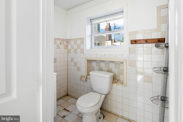 bathroom featuring toilet and tile walls