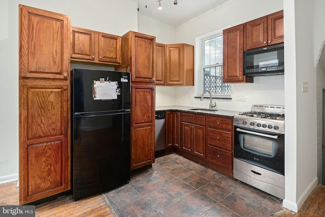 kitchen with black appliances, baseboards, brown cabinetry, and a sink