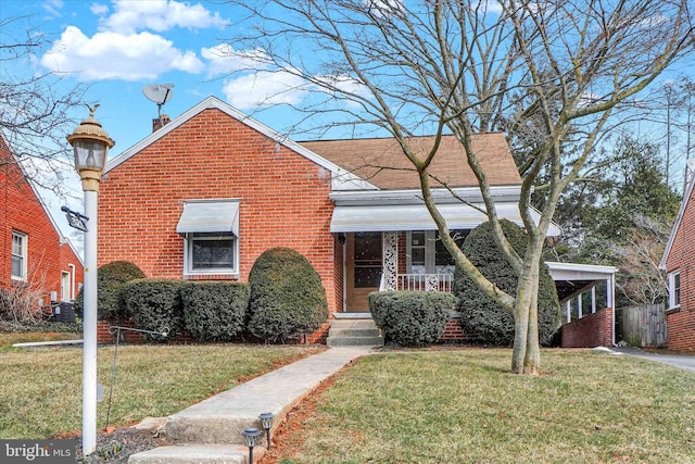 bungalow-style home featuring a front yard, brick siding, and a chimney