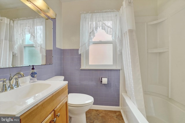 bathroom featuring tile walls, vanity, toilet, and shower / bathtub combination with curtain