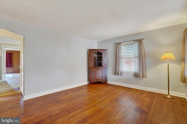 spare room with wood finished floors and baseboards