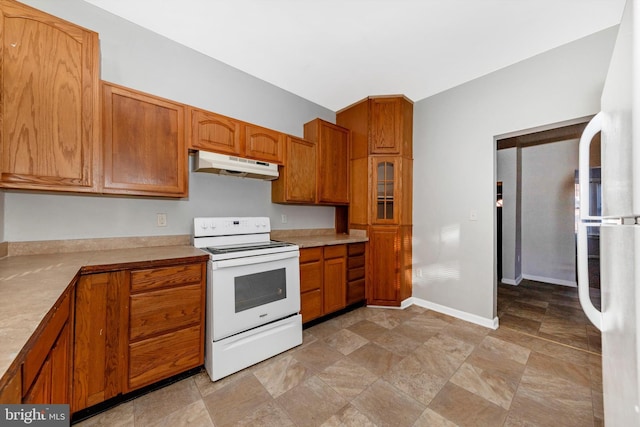 kitchen featuring light countertops, white appliances, brown cabinets, and under cabinet range hood