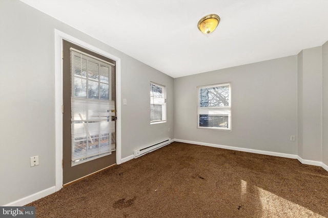 carpeted empty room featuring a baseboard radiator and baseboards