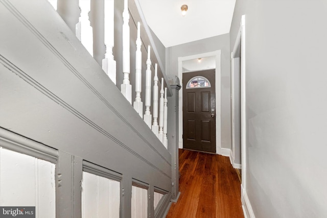 entryway featuring dark wood-style floors and baseboards