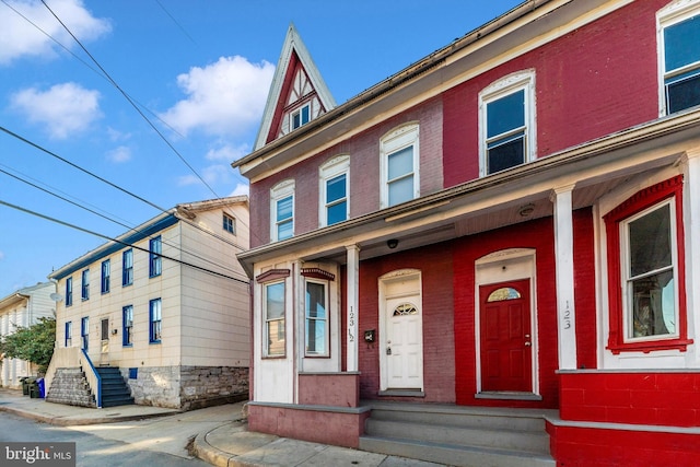 multi unit property with covered porch and brick siding