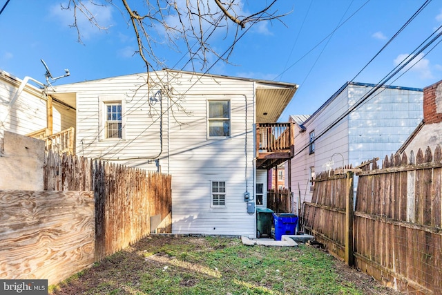 rear view of property featuring a fenced backyard