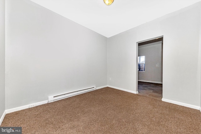 empty room with baseboard heating, carpet, and baseboards