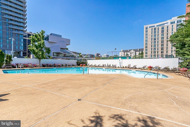 pool with fence and a patio