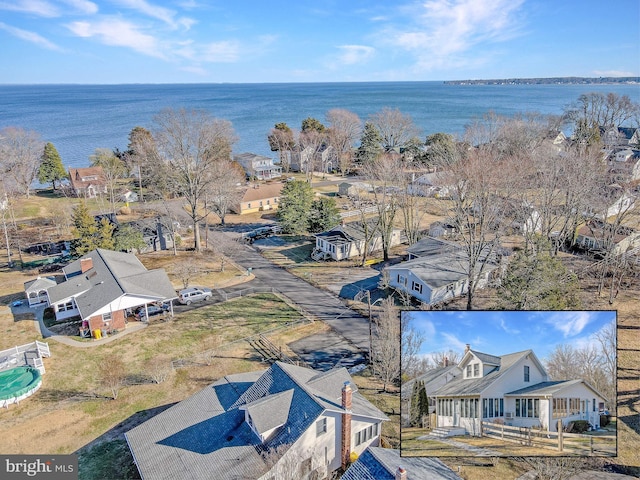 birds eye view of property with a water view and a residential view