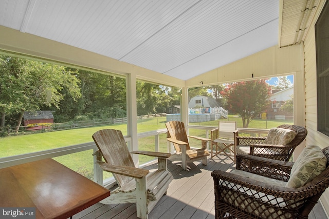 sunroom / solarium with a healthy amount of sunlight and vaulted ceiling