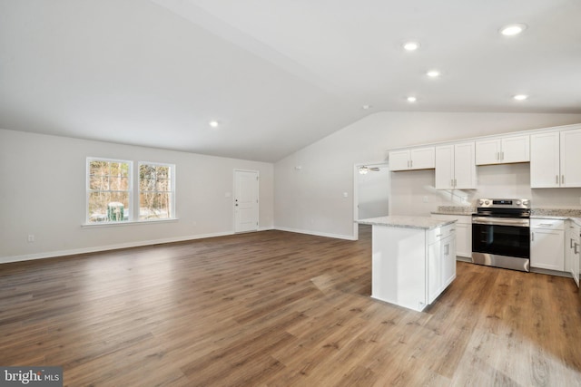 kitchen with a center island, open floor plan, white cabinets, and stainless steel electric range