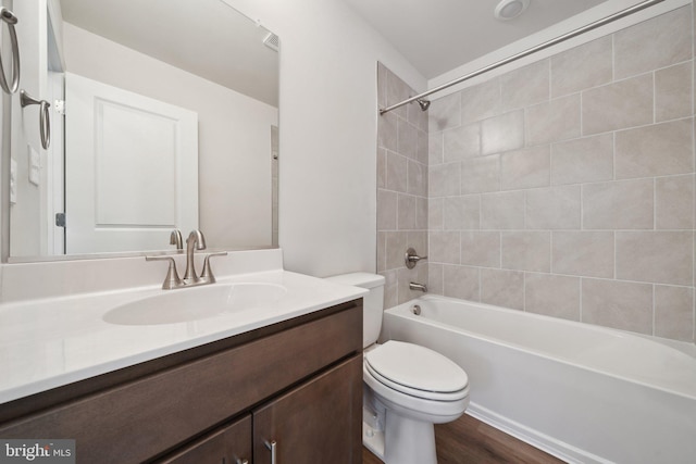 full bathroom featuring  shower combination, toilet, wood finished floors, and vanity