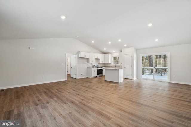 unfurnished living room with light wood-style flooring, baseboards, vaulted ceiling, and recessed lighting