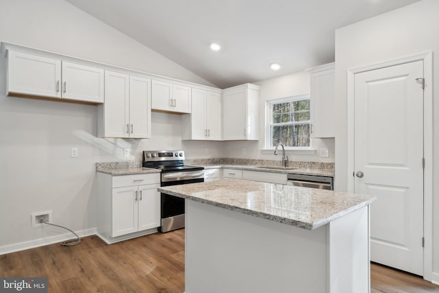 kitchen featuring a kitchen island, appliances with stainless steel finishes, white cabinets, and a sink