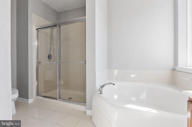 bathroom featuring toilet, a shower stall, vanity, tile patterned flooring, and a bath